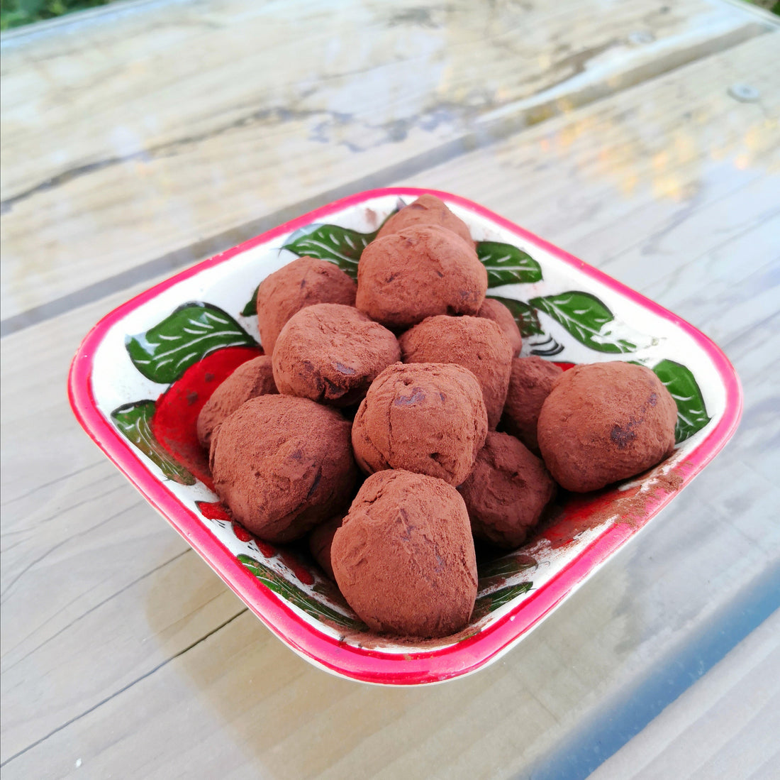 chocolate truffle balls coated in cocoa in a colourful bowl
