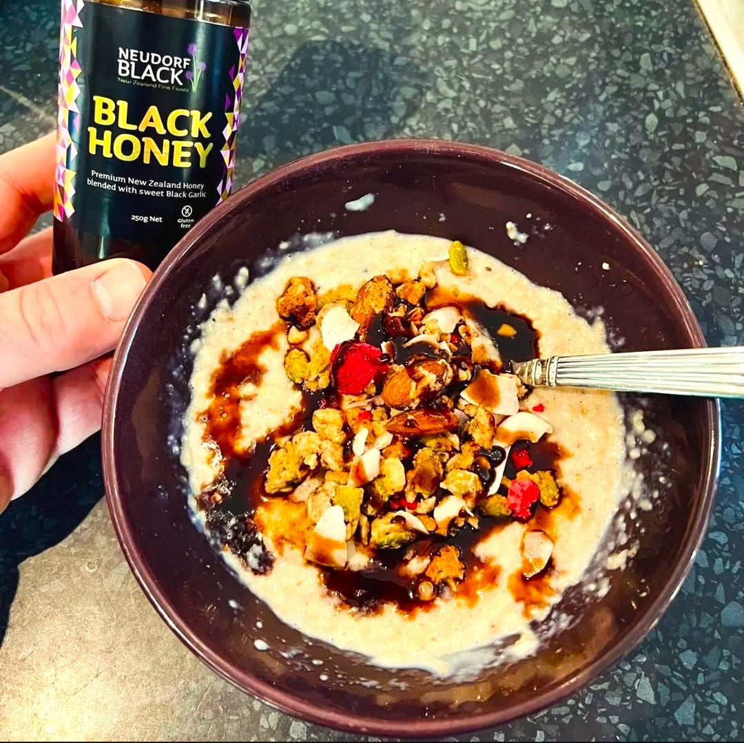 Neudorf Black Garlic Honey drizzled over a bowl of porridge and fruit