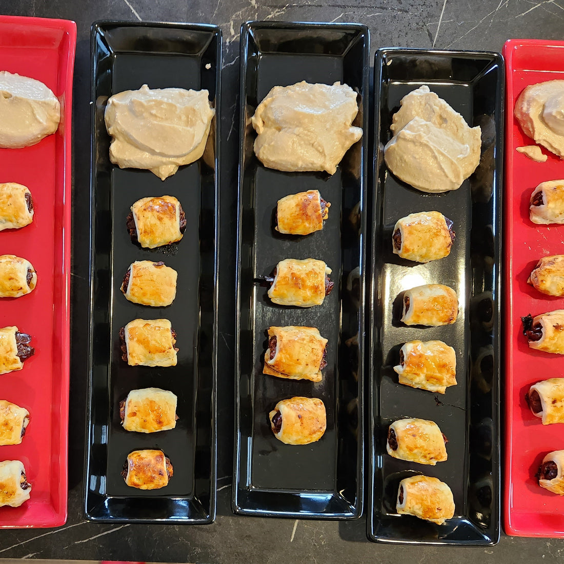 dates rolled in pastry lined up on a plate