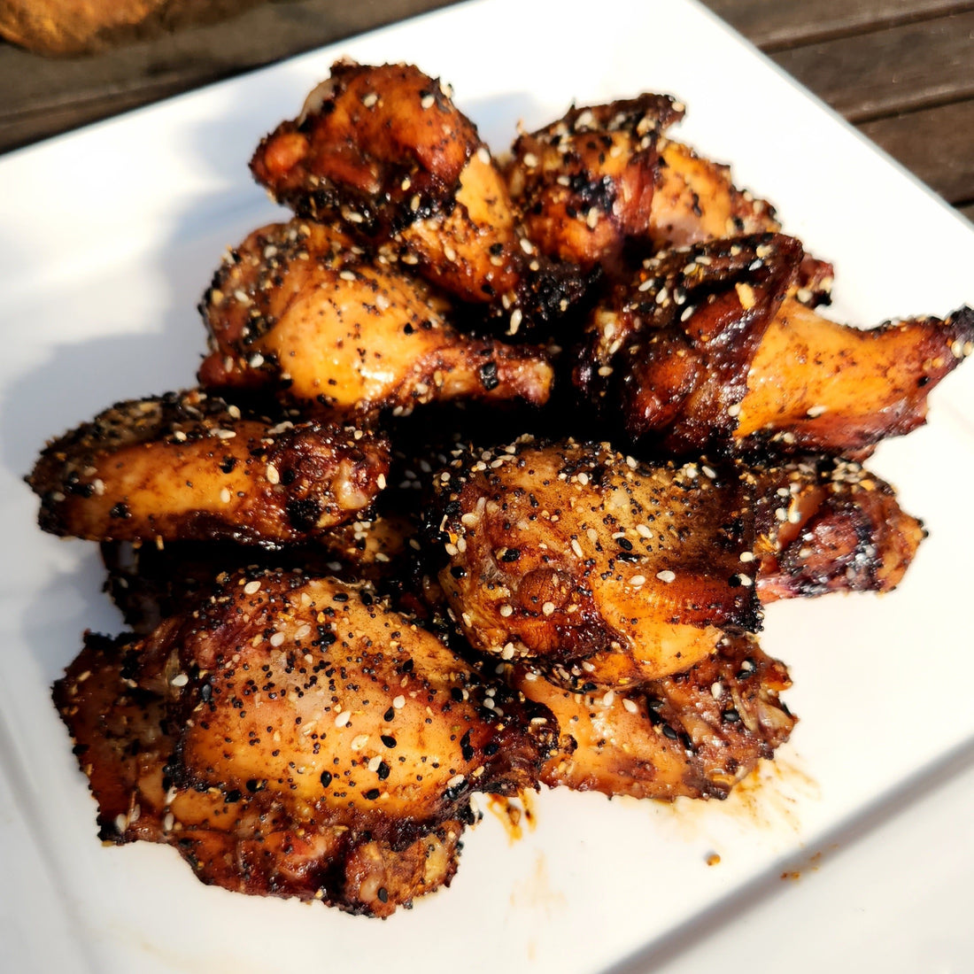 chicken nibbles with black garlic honey on a plate