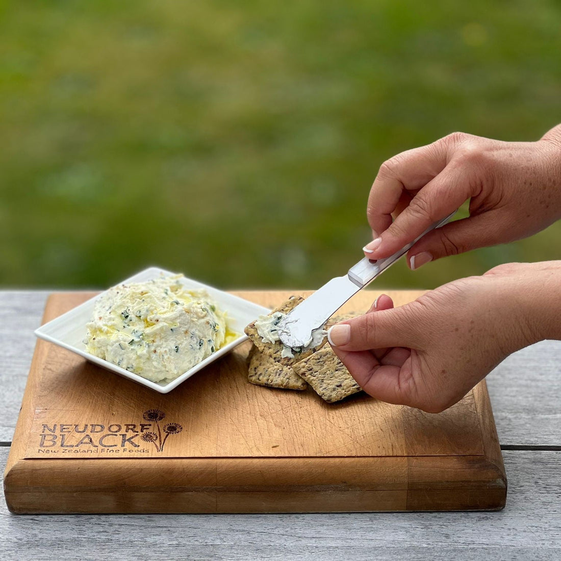 Herbed Ricotta with Black Garlic Olive Oil on crackers