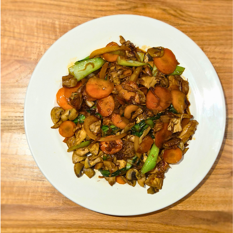 black garlic stirfry on a white plate