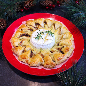 puff pastry dish made with cheese and black garlic on a red plate