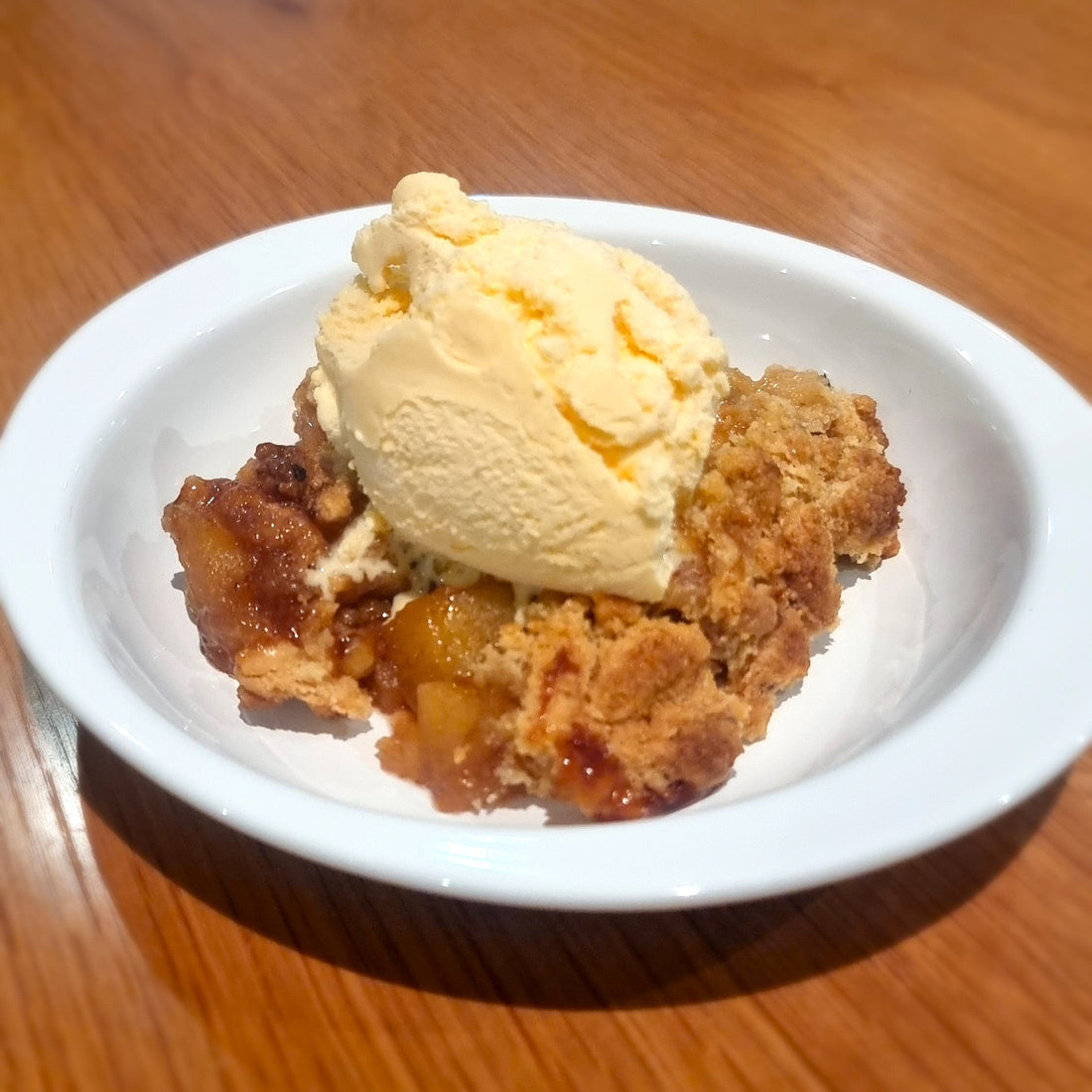 Fruit crumble with golden bubbliness in the dish