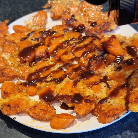 parmesan crusted carrot slices with Hot Black Garlic Honey drizzled over the top