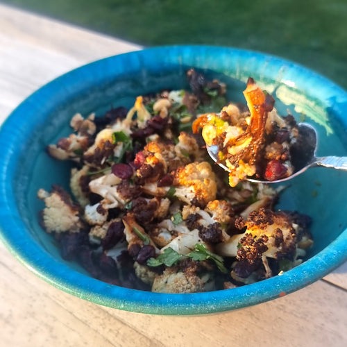 roast cauliflower salad with black garlic dressing in a bowl