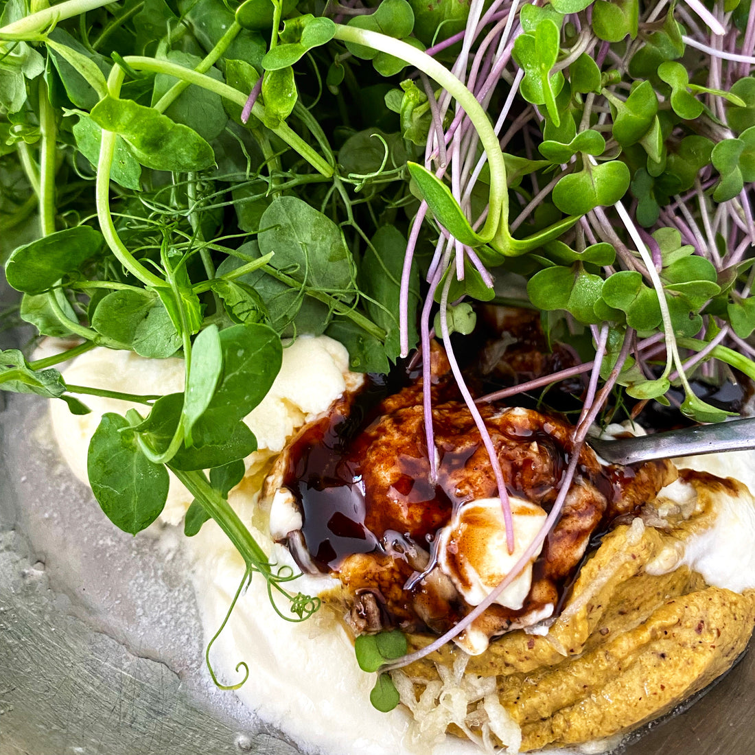 black honey on a yoghurt dressing with salad greens