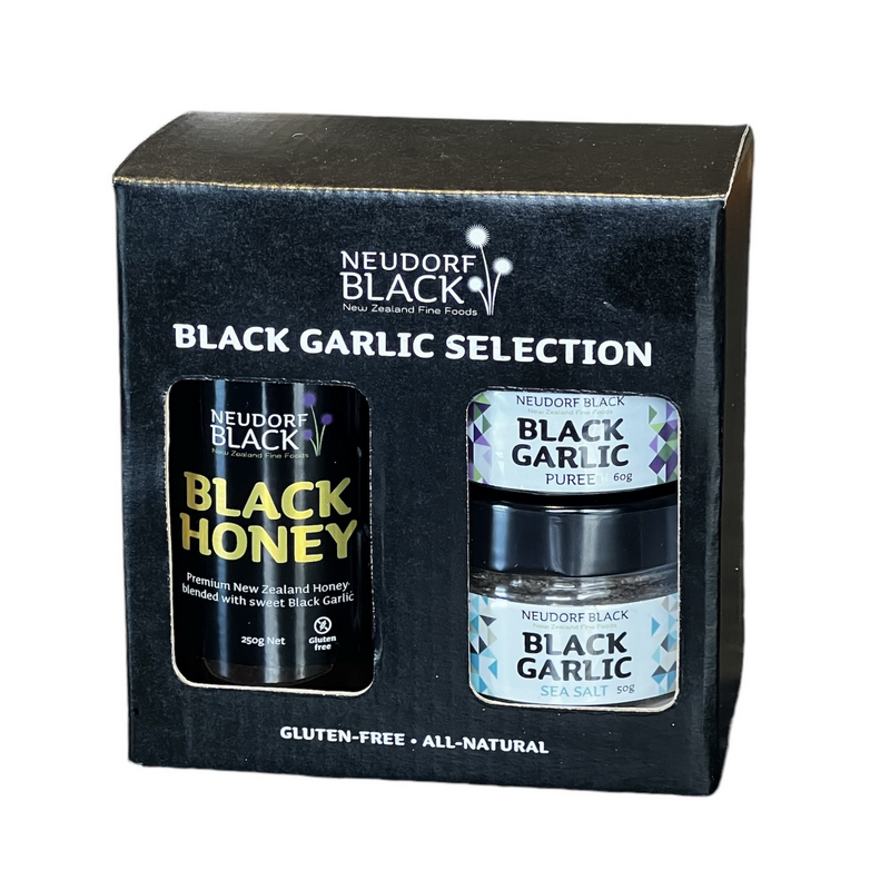 black garlic honey tube, black garlic puree jar and a jar of black garlic sea salt in a black and white presentation box