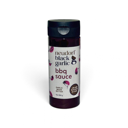 a bottle of Neudorf Black Garlic BBQ Sauce on a white background