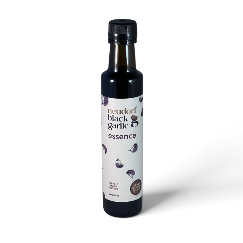A bottle of Neudorf Black Garlic Essence with a white label and black cap, set against a plain white background.