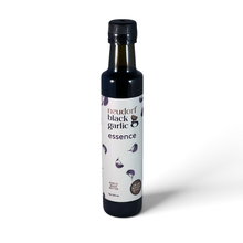 A bottle of Neudorf Black Garlic Essence with a white label and black cap, set against a plain white background.