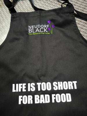 Black apron with text printed on it.